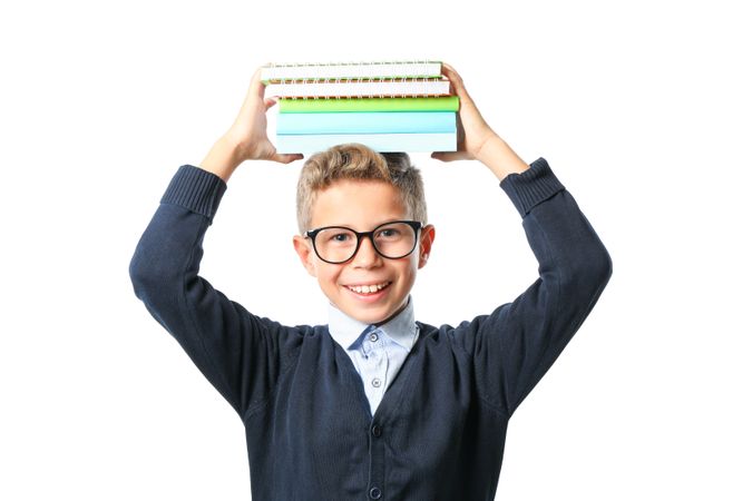 Boy with glasses and copybooks isolated on blank background