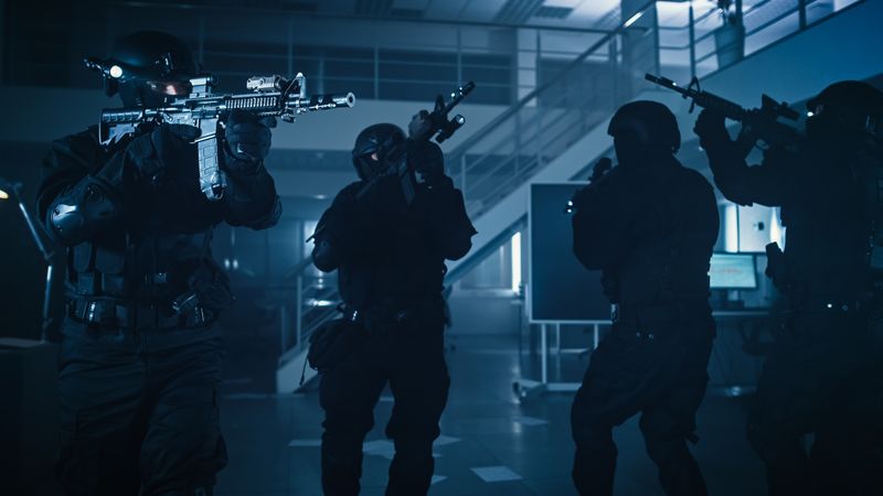 Soldiers with Rifles and Flashlights Move Forward and Cover Surroundings.