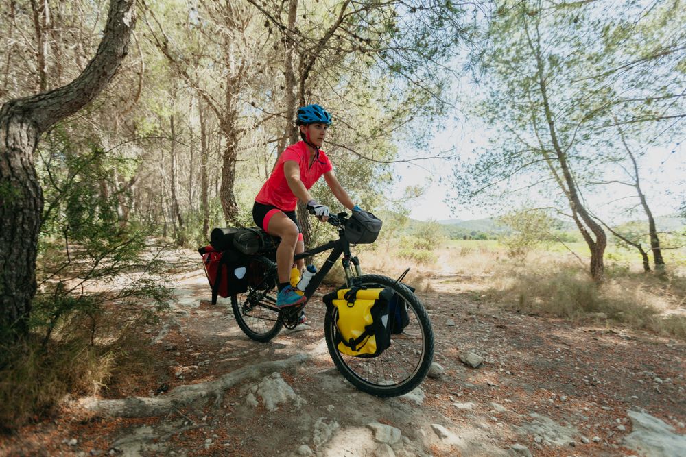 Woman riding bicycle in forest