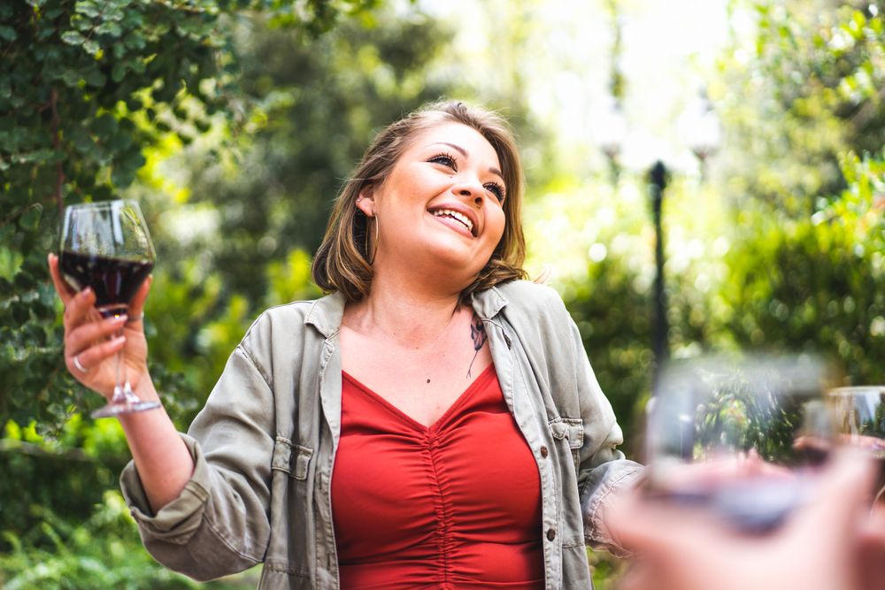 Happy woman with a glass of red wine