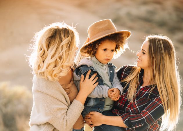 Smiling blond women walking with curly child