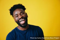 Portrait of joyful Black man on yellow background bDn9Q5