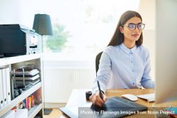 Female graphic designer working from pad at home office 4ADqm5