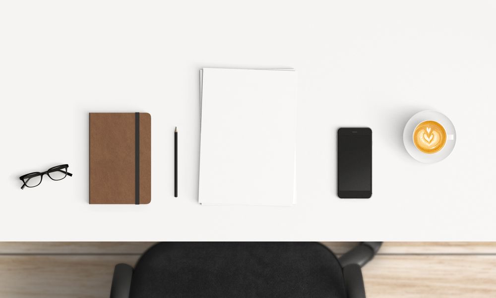 Modern workplace with coffee cup and smartphone or laptop copy space on table background. Top view. Flat lay style.