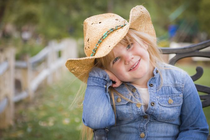 Cute Young Girl Wearing Cowboy Hat Posing for Portrait Outside