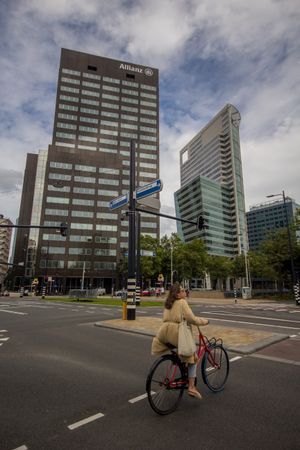 Woman riding a bicycle in the city of Rotterdam, Netherlands