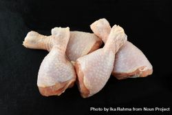 Raw chicken legs on dark background 0WBgOb