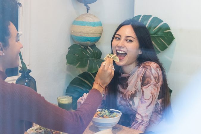 Friendly diverse women eating in restaurant together