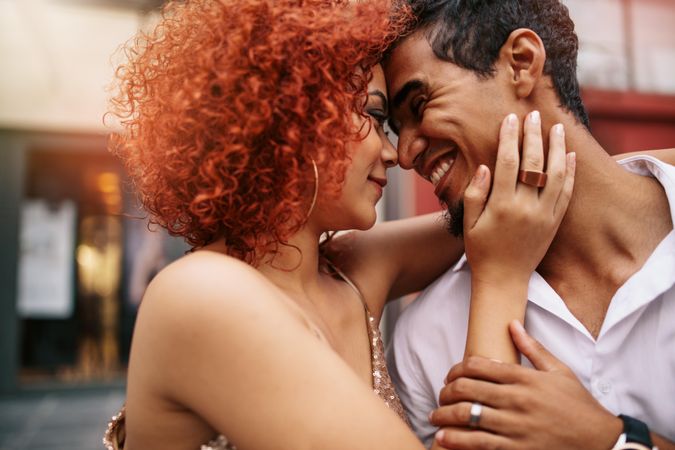 Close up of a young couple in a romantic mood smiling looking a each other
