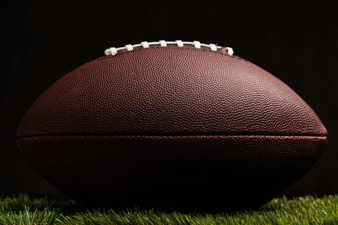 American football ball on dark background