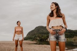 Smiling women looking away on beach