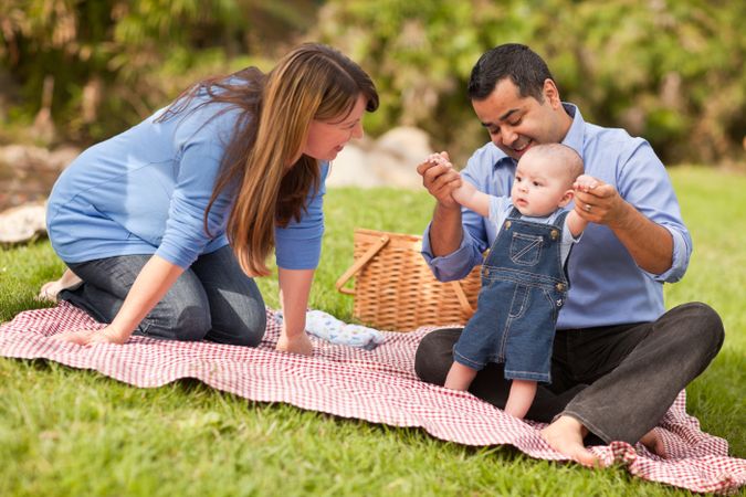 Happy Young Family Playing In The Park