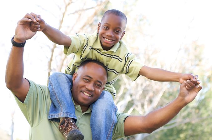Man and Child Having Fun At the Park Together