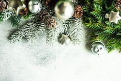 Christmas frame concept with pine branch and star and bell ornaments