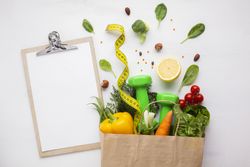 Bag with groceries, weights, measuring tape and copy space