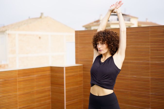 A Young Woman Engaged in Practicing Yoga Outdoors While Wearing Stylish Activewear