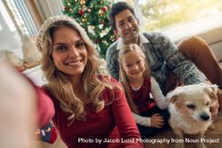 Caucasian family taking photos at Christmas 56GMQL