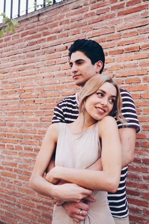 Happy couple having fun and embracing in the street