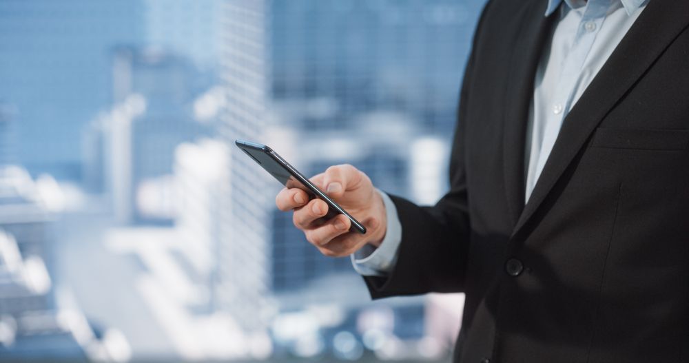 Successful Businessman Going Through Emails, Schedule, Chatting Online or Purchasing Products.