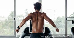 Muscular male’s back on treadmill near window 49rJWb