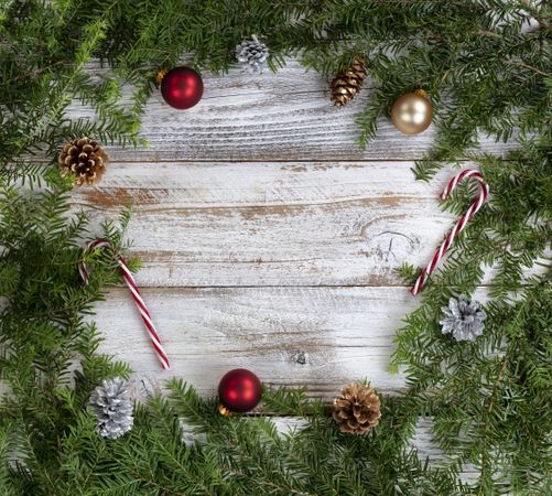 Real fir wreath with traditional decoration ornaments on rustic wood background for the Christmas or New Year holiday
