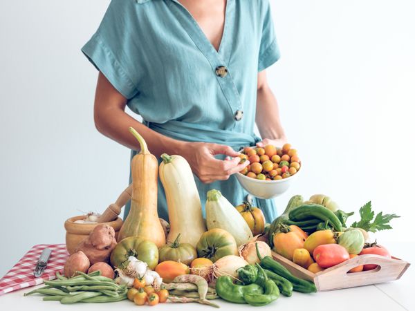 Crop woman with fresh ripe vegetables