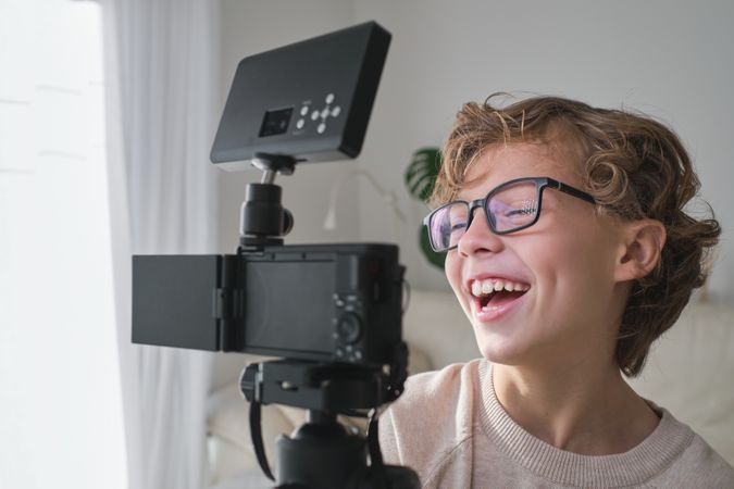 Teen smiling at camera while shooting vlog