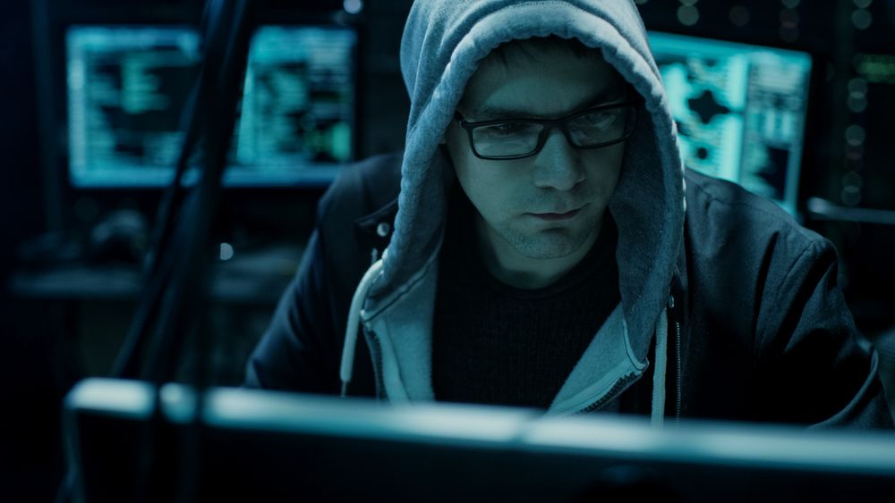 Hooded Hacker Breaks into Government Data Servers and Infects Their System with a Virus.