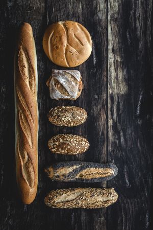 Assorted gold homemade bread on dark wood background