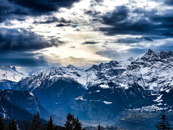 Swiss Alps winter landscape with snow and sun, mountains in Europe
