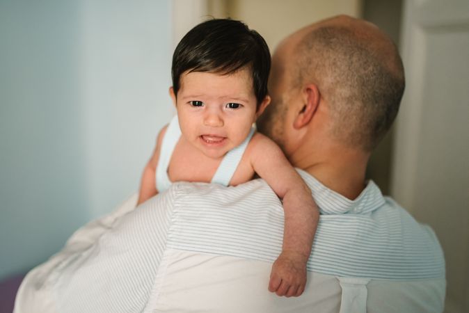 Father hugging cute baby