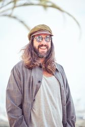 Cheerful man in sunglasses on street