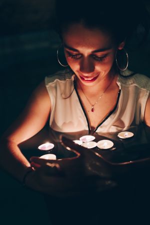 Woman swimming in pool with candles
