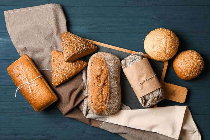Flat lay composition with bakery products on wooden background, top view and space for text