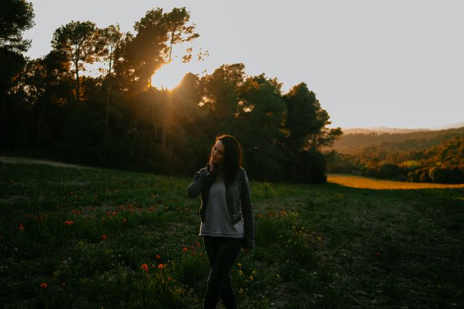 Woman walking on meadow and enjoying freedom