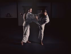 Man kicking woman during Krav Maga training