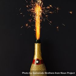 Golden champagne party bottle onbackground with fire sparklers 4jGLXb