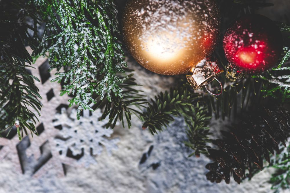 Christmas card concept or snow flakes on pine branch with baubles