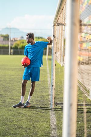 Black teenager on football field