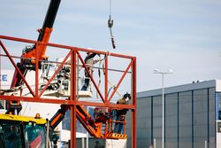 Men welding a billboard