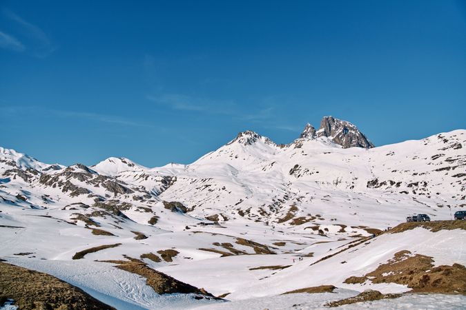 Snowy hilly landscape under blue sky