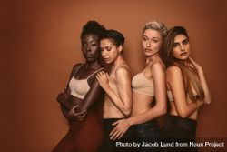 Group of four diverse young women on brown background 5QxmG0