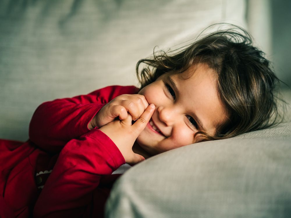 Cute dreamy girl lying down on pillow