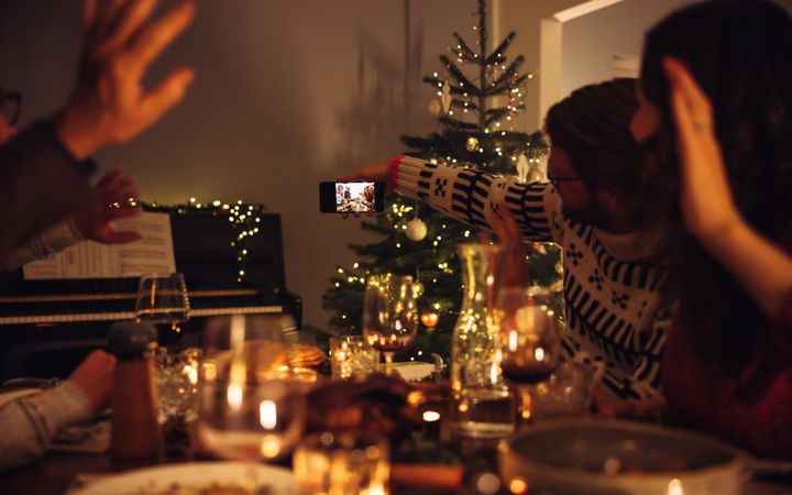 Family posing for a selfie during Christmas dinner