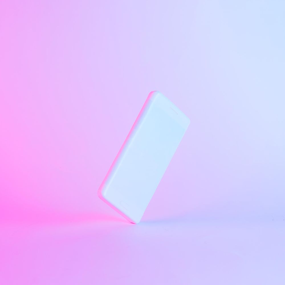 Smartphone painted light paint with vibrant bold gradient purple and blue holographic color lights