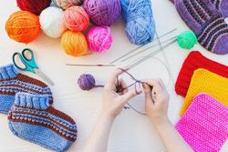 Woman knitting using colorful yarn