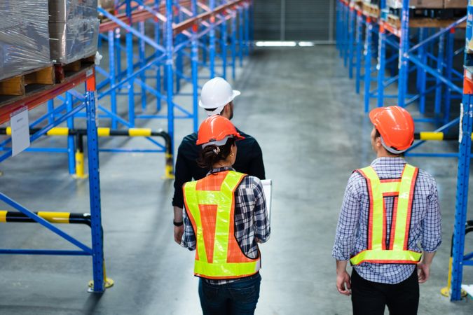 Multi-ethnic group of colleagues checking stock in the shipping center