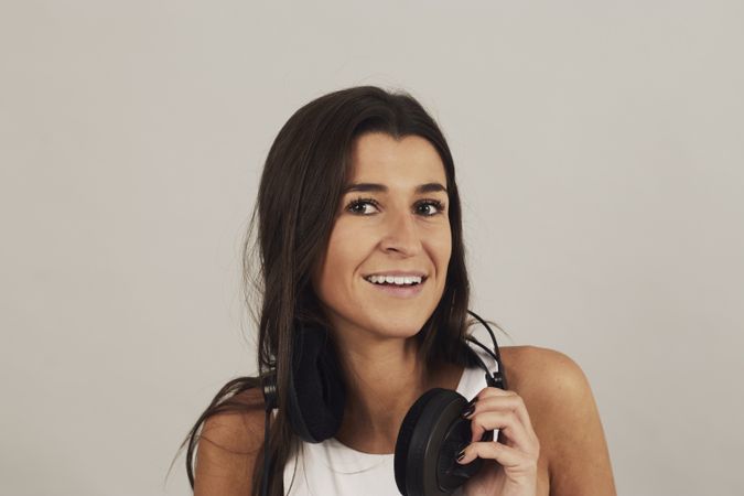 Thoughtful young woman enjoying music in studio