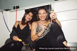 Happy women friends having fun at home enjoying wine 0VwVO5