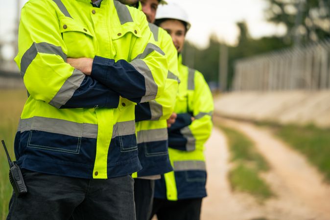 Banner background of engineer in arms crossed standing in a row standing at construction site